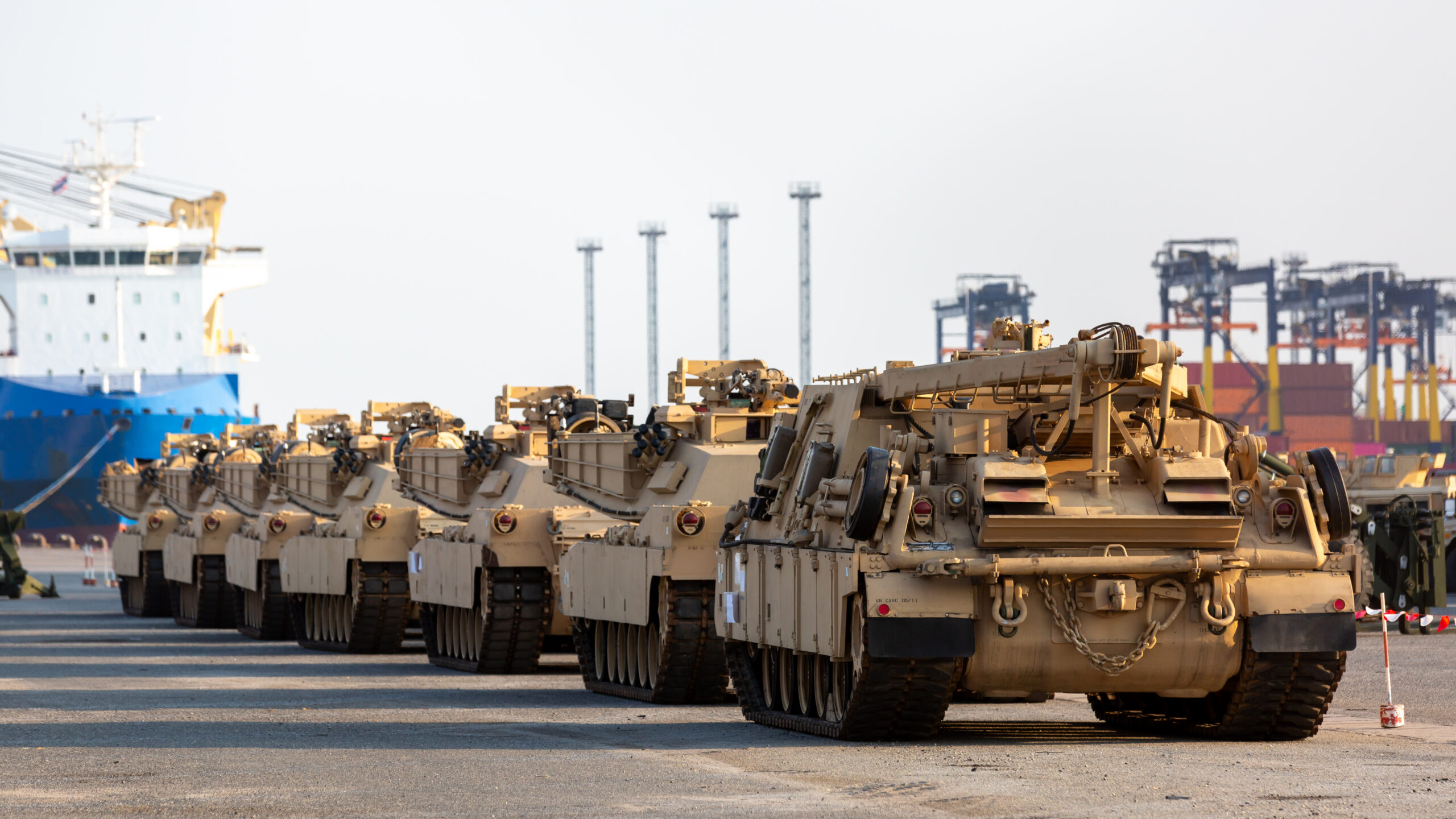 Military vehicles at deep sea port for import export logistic tr