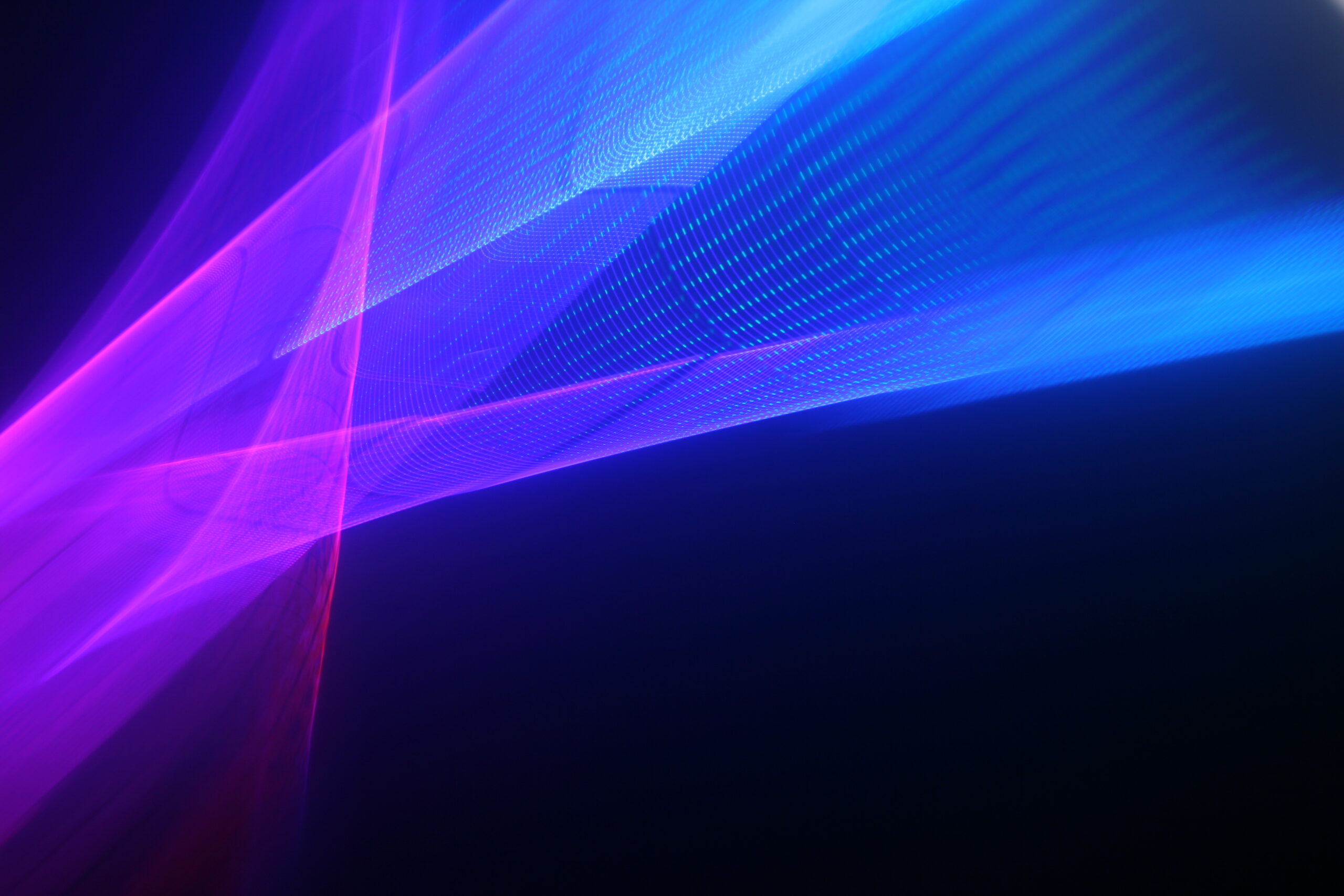 Large display featuring a pattern of purple and blue lights radiating outward along distinct lines