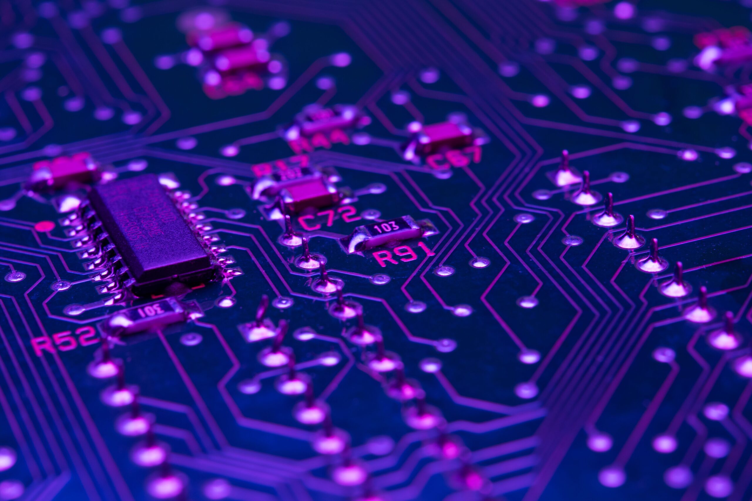 Close-up macro shot of a complex circuit board with various electronic components and wiring
