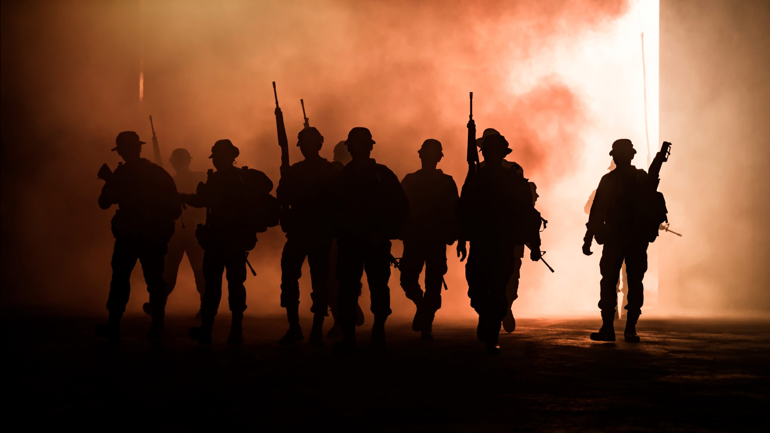 silhouette-of-man-with-rifles-as-soldiers-walk-thr-2025-02-03-10-14-59-utc