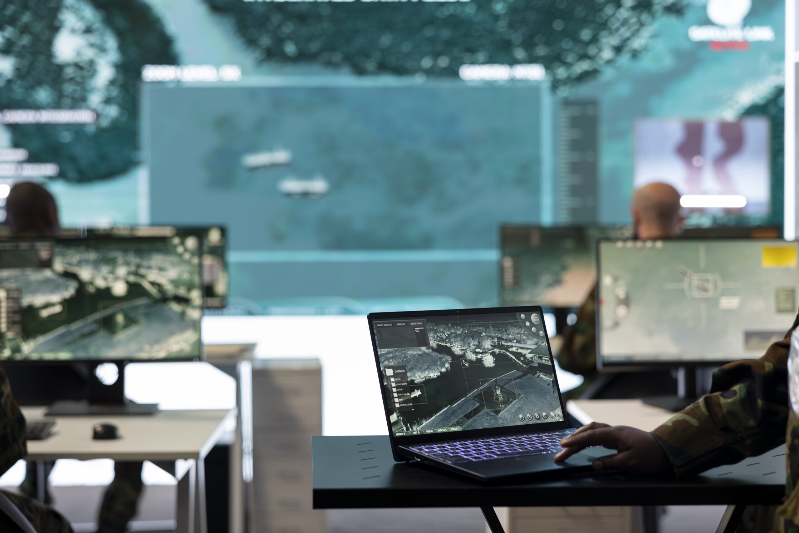 Woman soldier working on military reconnaissance system in control room