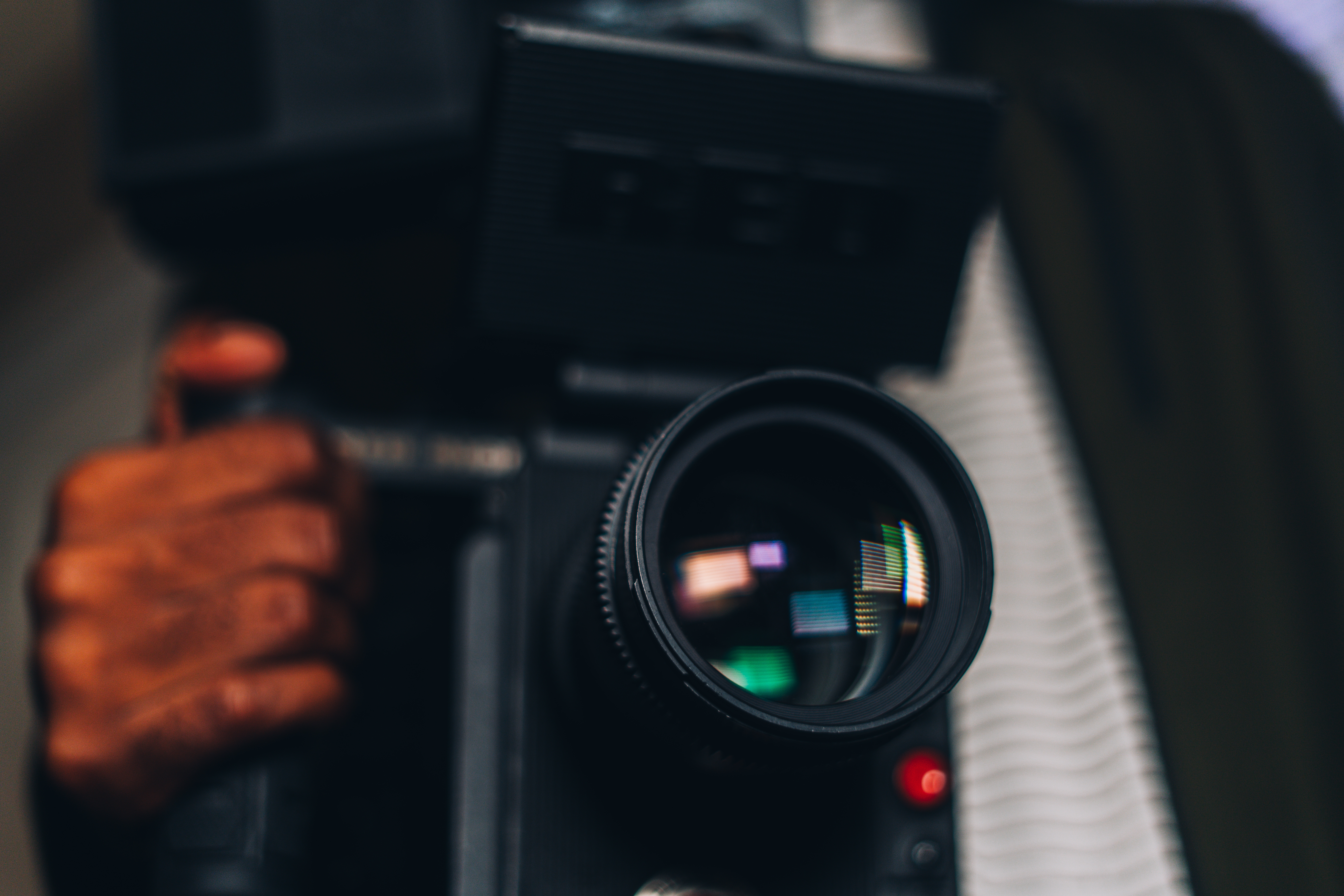 Selective focus shot of a male hand holding a camera